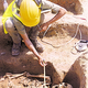An archaeologist examines the intact remains of a spooky “skeleton person.”